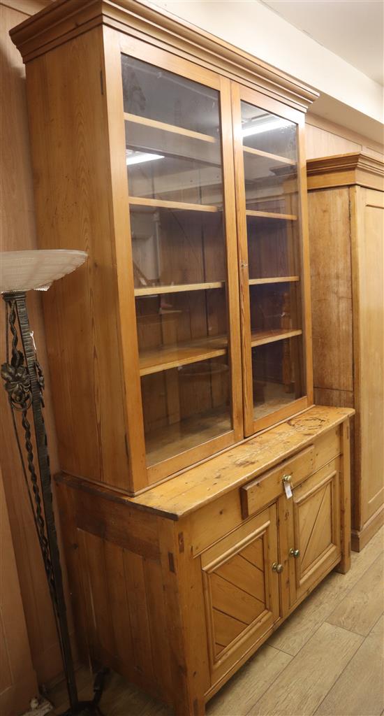 A 19th century continental pine bookcase cupboard W.130cm